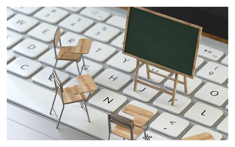 Blackboard and chairs on the keyboard of a latop, 3d rendering,c